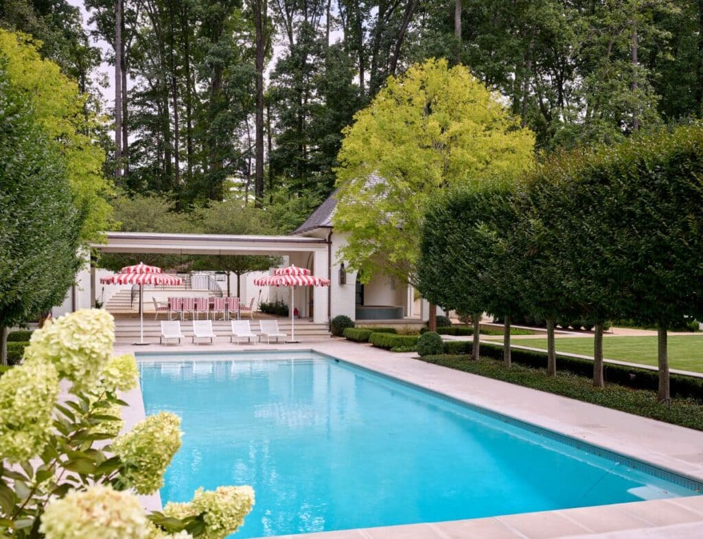 Swimming pool bordered by pleached hornbeams.