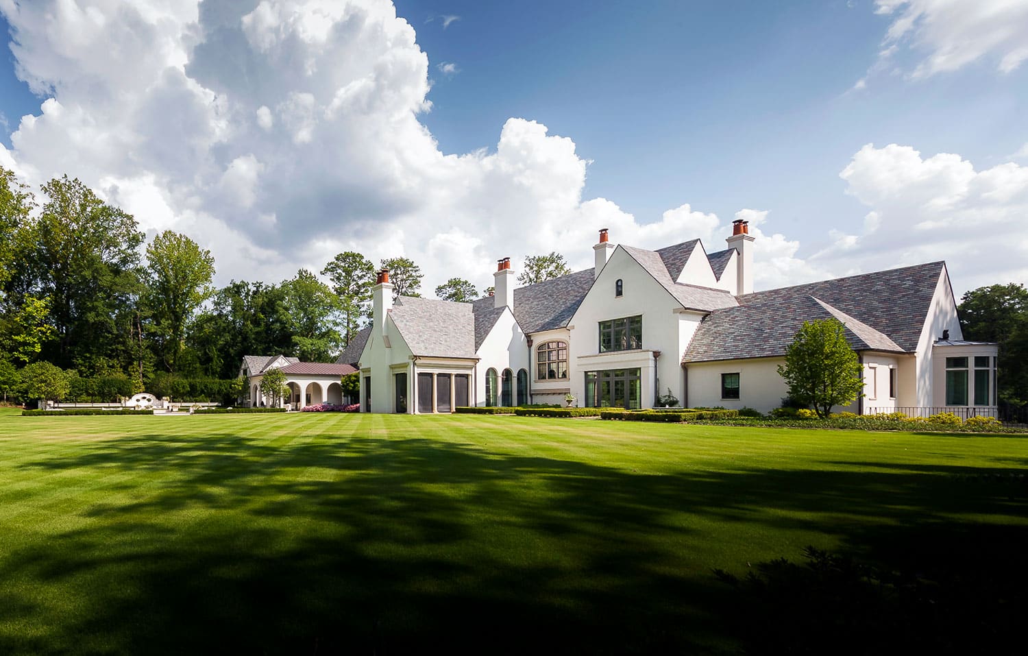Featuring lush, green turf expanding the vast backyard of a contemporary Atlanta estate property.